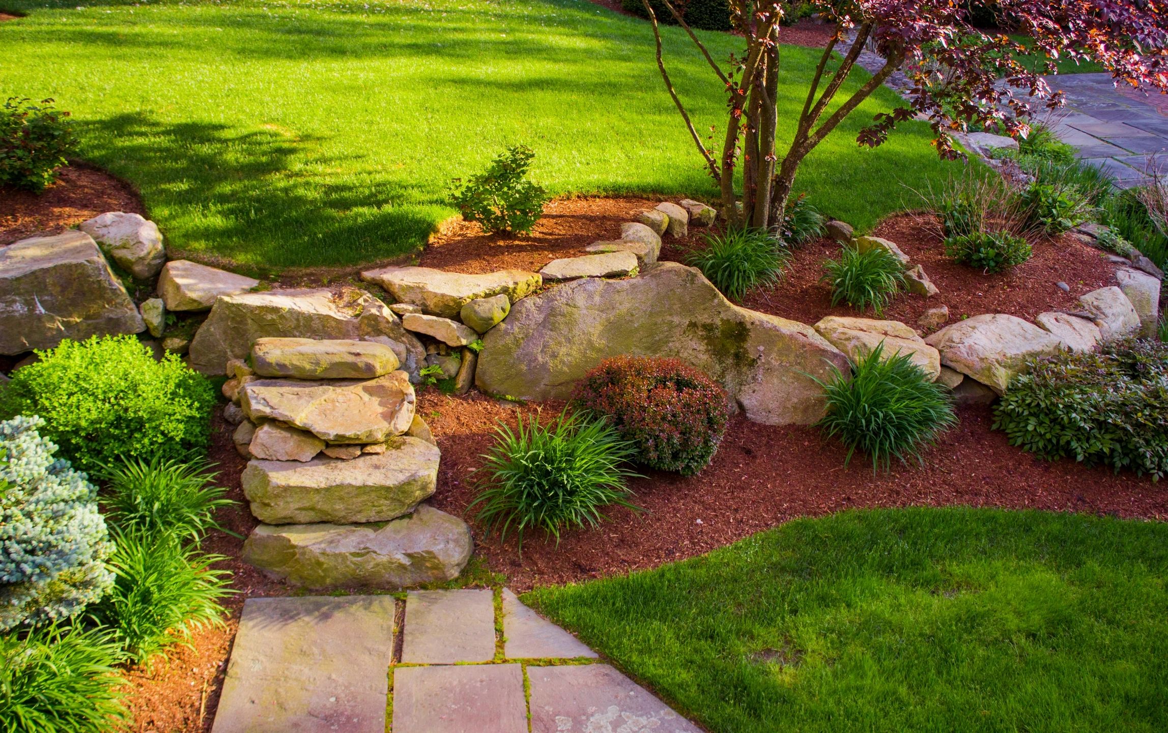 Stone retaining wall with landscaped garden